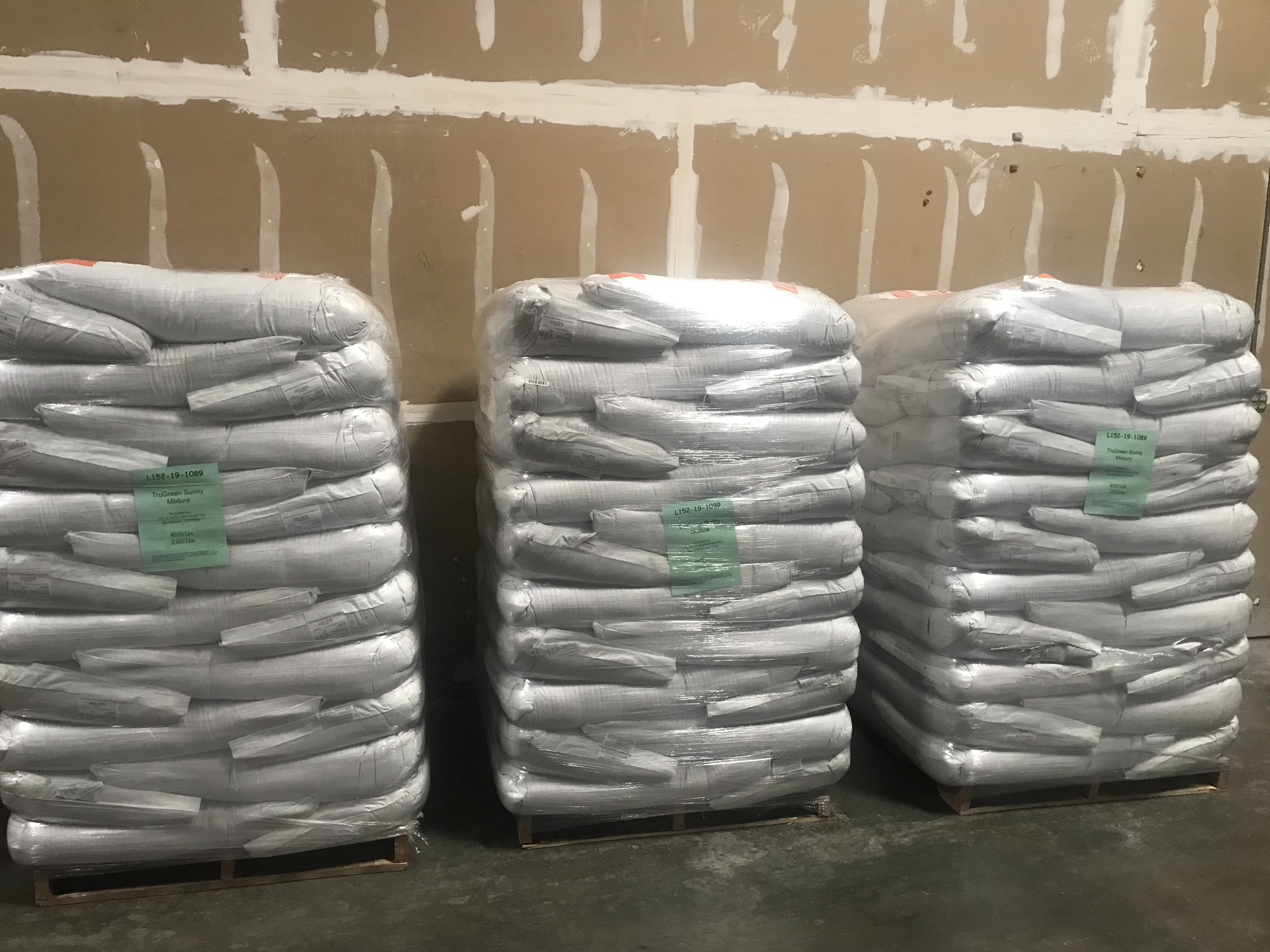 Bags of seed stacked on pallets